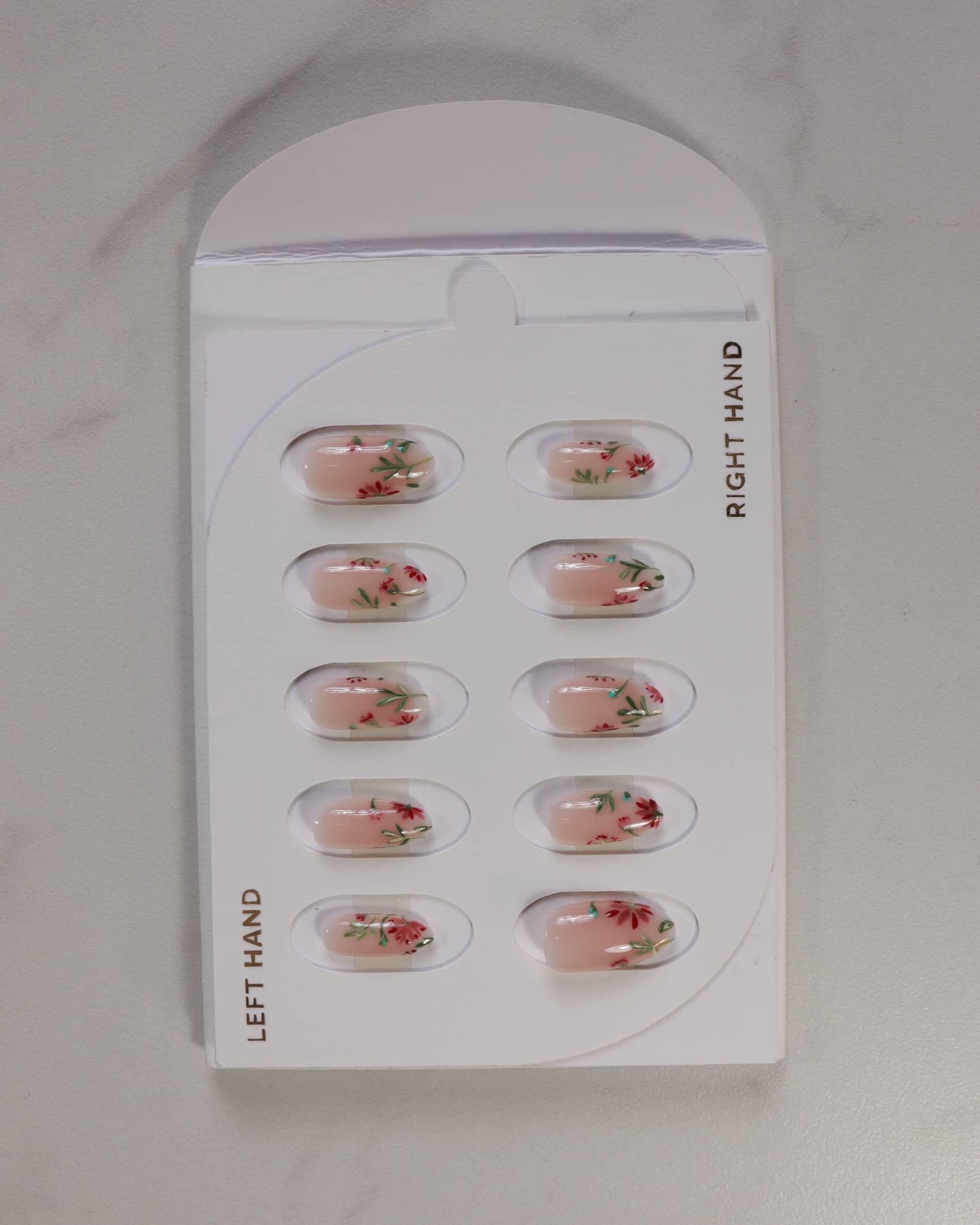 Packaged nail art stickers with floral designs on a white background