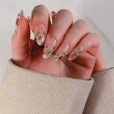 Hand with floral nail design on a neutral background
