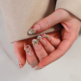 Close-up of a hand with floral nail design against a neutral background