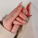 Hand with floral nail design on a neutral background