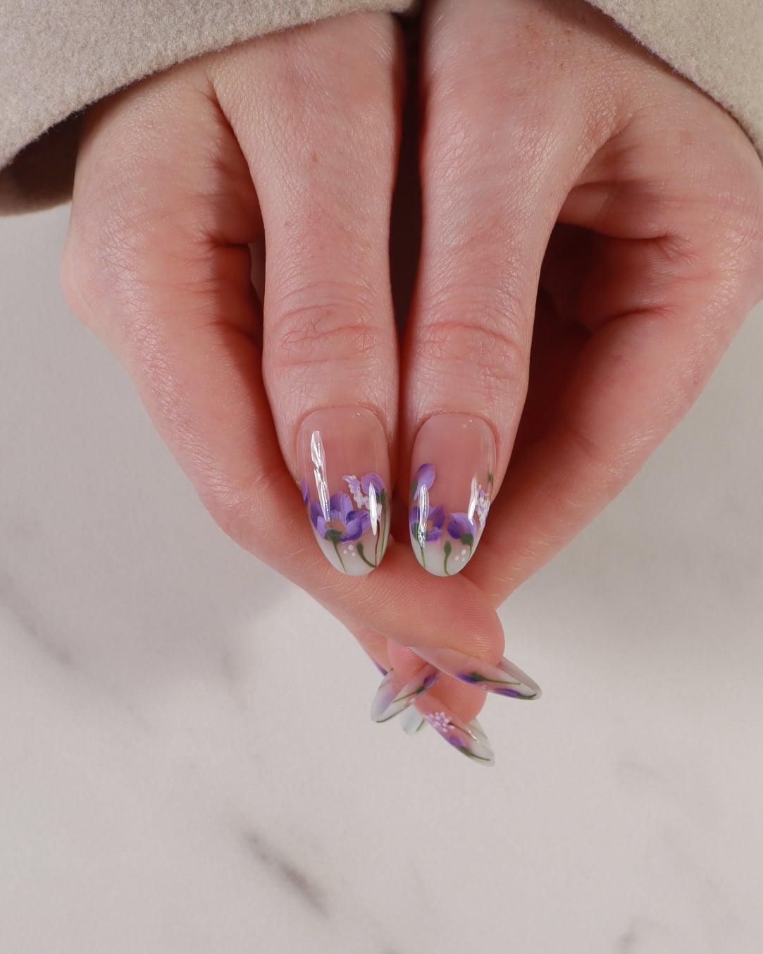 purple flowers nail extensions on hand