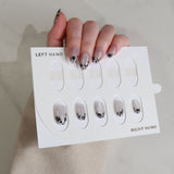 Nail art display card with nail designs held by a hand