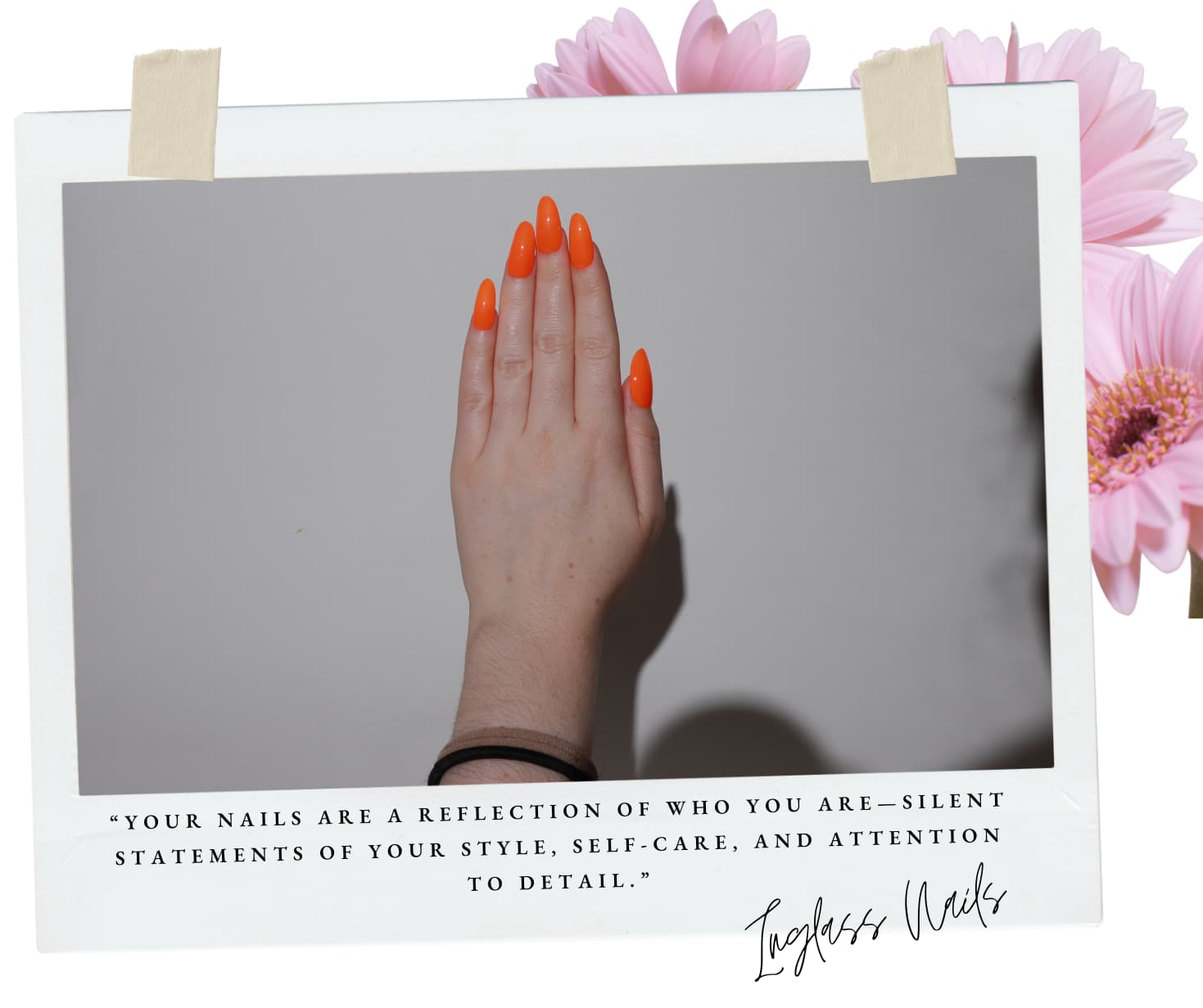 Hand with orange nails against a gray background, framed with pink flowers.